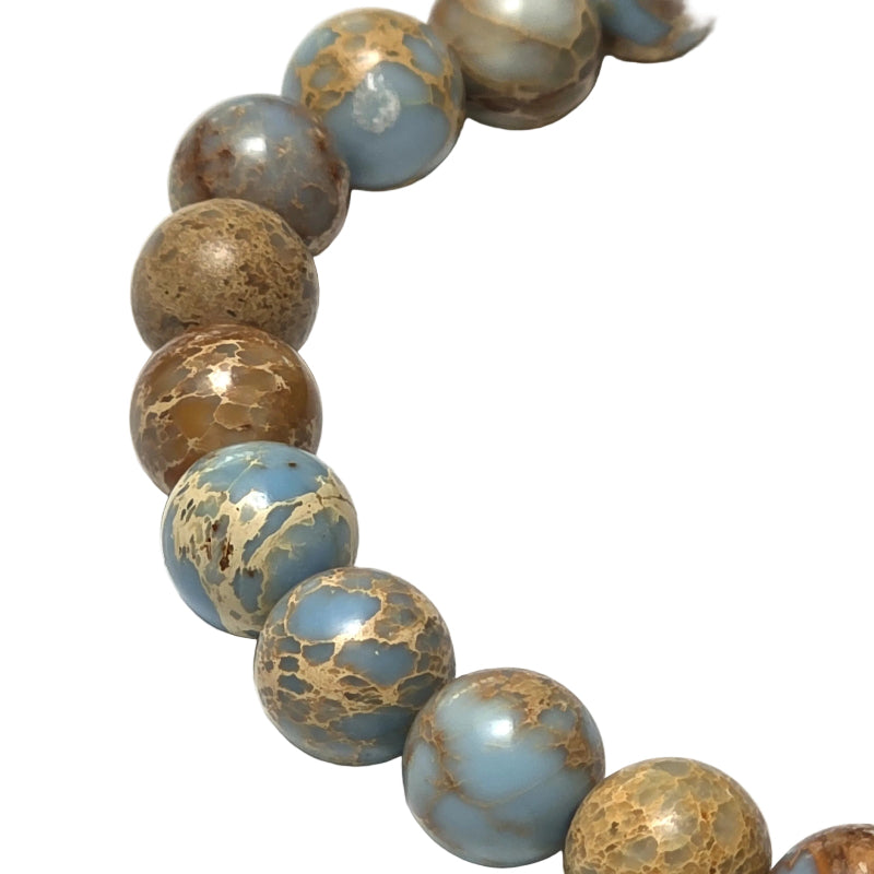 Close up view of the unique natural patterns on the blue violet imperial jasper beads of the Reiki infused Ocean bracelet.