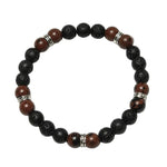 Black Terra bracelet featuring 8mm black lava rock and mahogany obsidian crystal beads with 90s tribal silver findings on a white background.