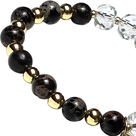 clear glass and black patterned bead brace with gold beads