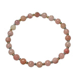 pink beaded bracelt with gold and silver small bead accents