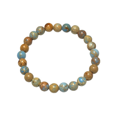 The Ocean bracelet featuring striking 8mm blue violet sea sediment imperial jasper gemstones on durable stretch cord.