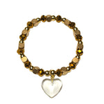 gold and copper beads with a clear glass heart