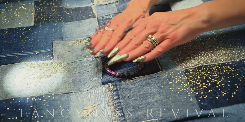 Load video: hands giving reiki to a bracelet with sparkles in the background