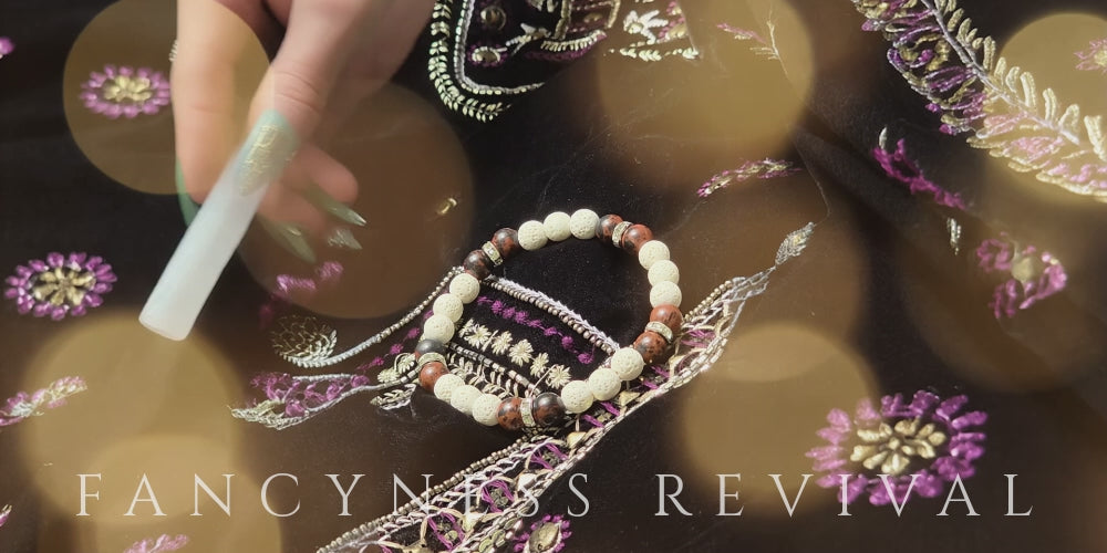 Load video: hands giving reiki to a bracelet with sparkles in the background