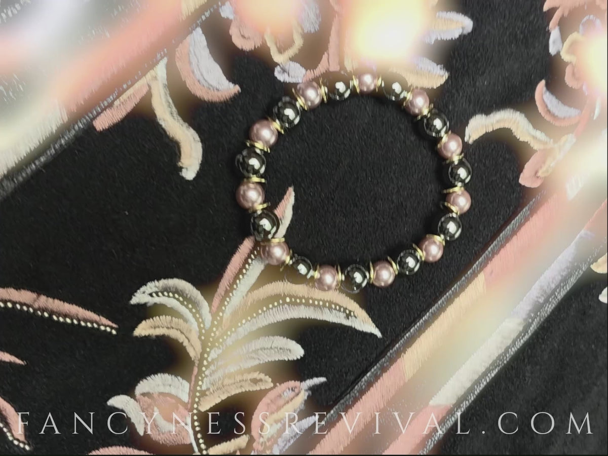 Load video: hands with fancy nails giving the bracelet reiki with a glow