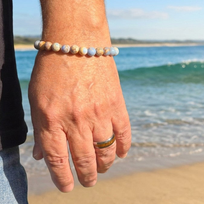 A sunlit wrist view of The Ocean crystal bracelet by Fancyness Revival channeling California coast style and tranquil energy.